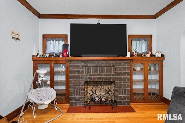 2531 5th St, Moline, IL 61265 - living area with ornamental molding, wood finished floors, a brick fireplace, and a textured wall