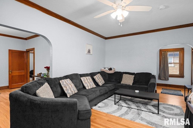 2531 5th St, Moline, IL 61265 - living room with arched walkways, wood finished floors, a ceiling fan, and ornamental molding