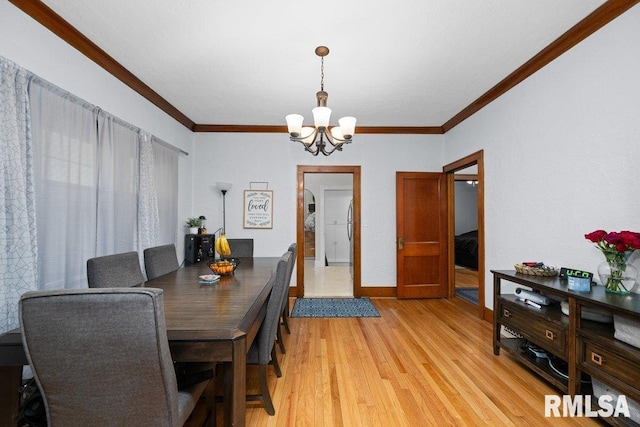 2531 5th St, Moline, IL 61265 - dining space featuring a chandelier, ornamental molding, and light wood-style floors