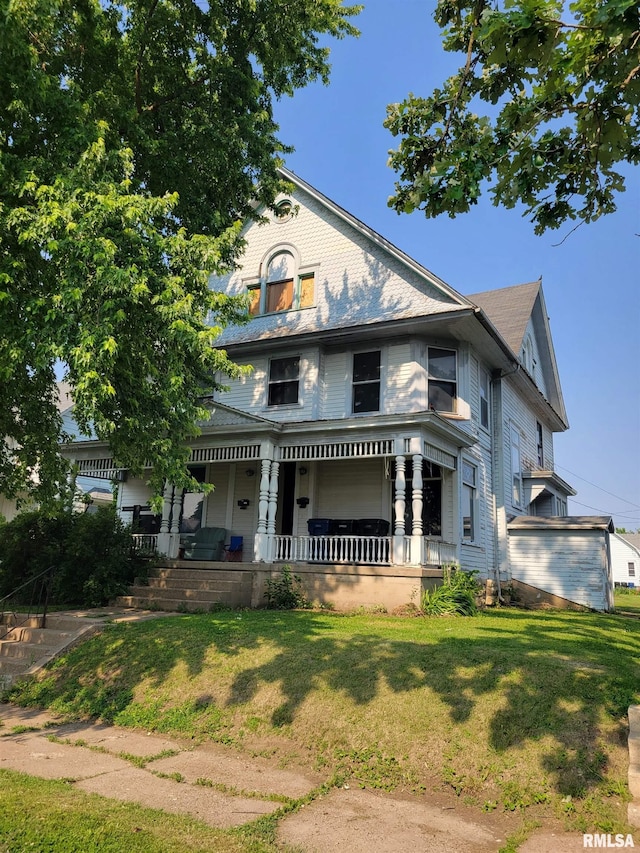 606 Meridian St Unit 1 & 2, Tipton, IA 52772 - victorian-style house featuring covered porch and a front yard