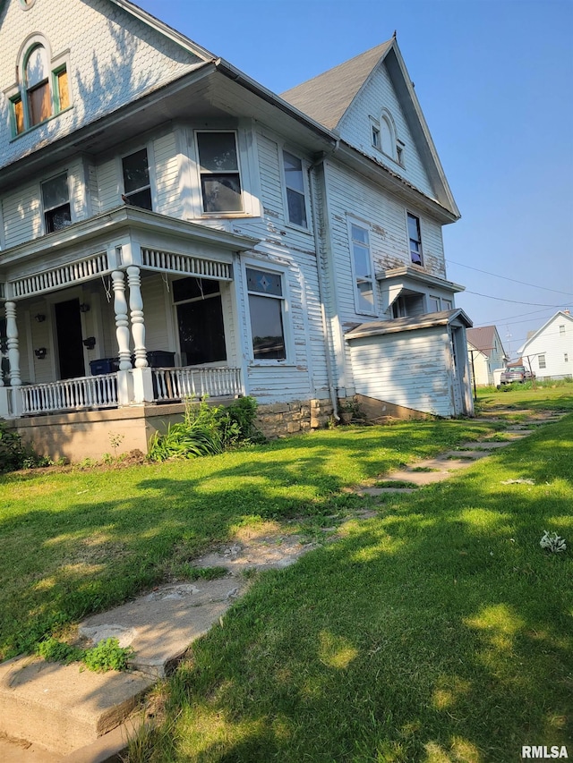 606 Meridian St Unit 1 & 2, Tipton, IA 52772 - view of home's exterior with a porch and a lawn