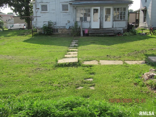 606 Meridian St Unit 1 & 2, Tipton, IA 52772 - view of front of home featuring a sunroom and a front lawn