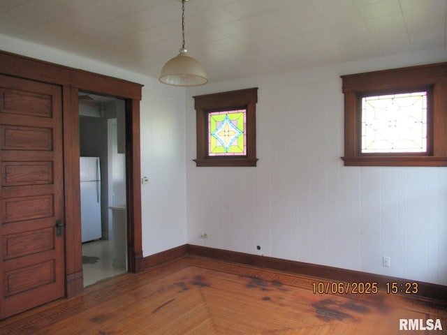 606 Meridian St Unit 1 & 2, Tipton, IA 52772 - spare room with baseboards and wood finished floors