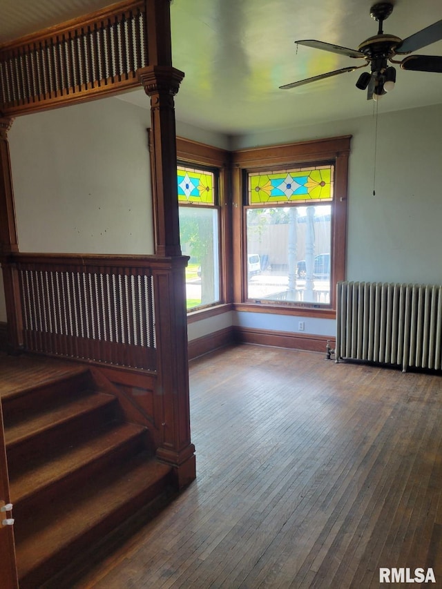 606 Meridian St Unit 1 & 2, Tipton, IA 52772 - stairs featuring radiator heating unit, plenty of natural light, ceiling fan, and wood-type flooring