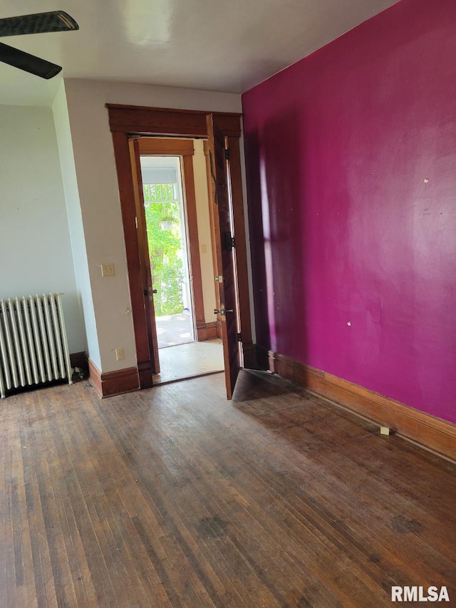 606 Meridian St Unit 1 & 2, Tipton, IA 52772 - empty room featuring radiator and wood-type flooring