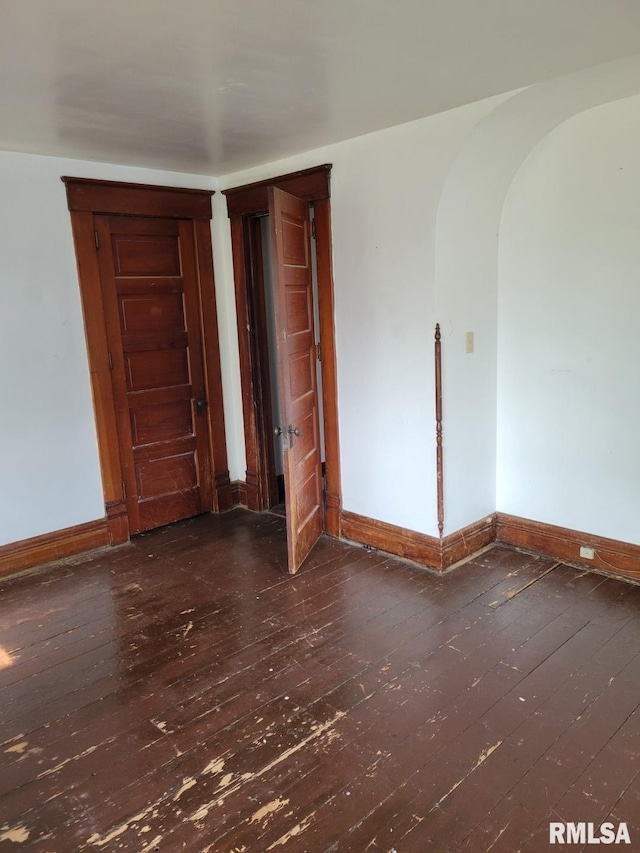 606 Meridian St Unit 1 & 2, Tipton, IA 52772 - spare room with hardwood / wood-style flooring and arched walkways