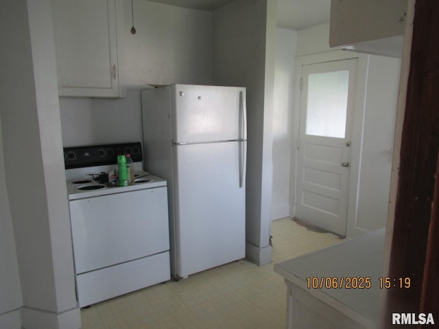 606 Meridian St Unit 1 & 2, Tipton, IA 52772 - kitchen featuring white appliances, light flooring, white cabinets, and light countertops
