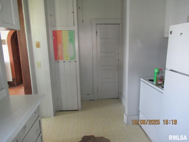 606 Meridian St Unit 1 & 2, Tipton, IA 52772 - kitchen featuring freestanding refrigerator, light flooring, light countertops, and arched walkways