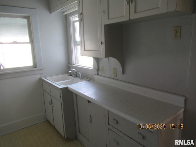 606 Meridian St Unit 1 & 2, Tipton, IA 52772 - kitchen with light floors, white cabinetry, and light countertops