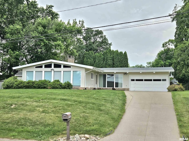 2020 Bidwell Rd, Muscatine, IA 52761 - mid-century home with an attached garage, driveway, a front yard, and a chimney