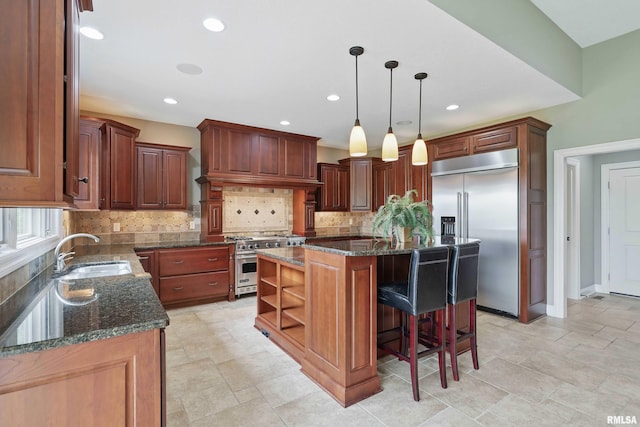 11 Sandstone Ct, Le Claire, IA 52753 - kitchen with high quality appliances, tasteful backsplash, a center island, dark stone countertops, and open shelves