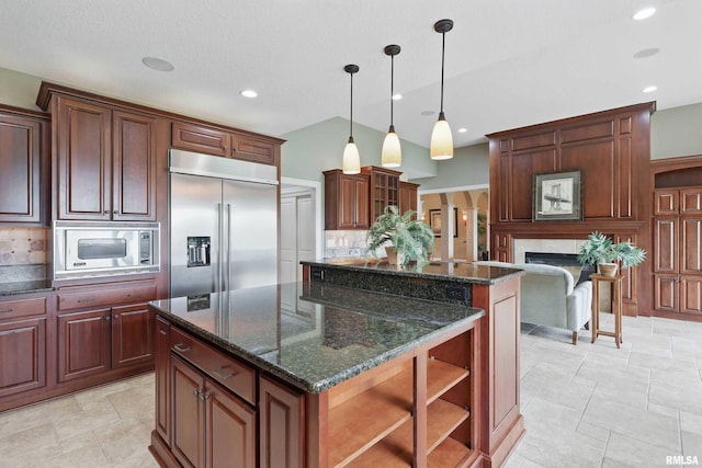 11 Sandstone Ct, Le Claire, IA 52753 - kitchen featuring built in appliances, a center island, tasteful backsplash, a fireplace, and recessed lighting