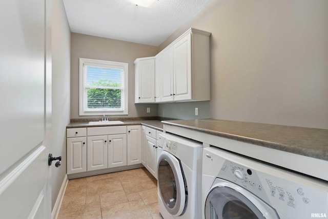 11 Sandstone Ct, Le Claire, IA 52753 - washroom with washer and dryer, cabinet space, and a textured ceiling