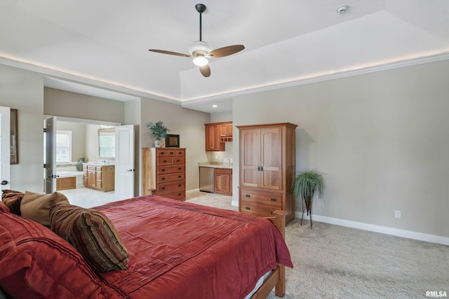 11 Sandstone Ct, Le Claire, IA 52753 - bedroom with connected bathroom, light carpet, ceiling fan, and a tray ceiling