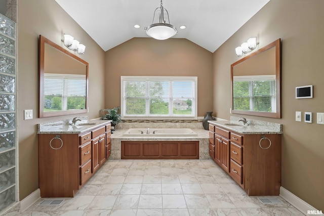 11 Sandstone Ct, Le Claire, IA 52753 - full bathroom with plenty of natural light, two vanities, a garden tub, vaulted ceiling, and recessed lighting
