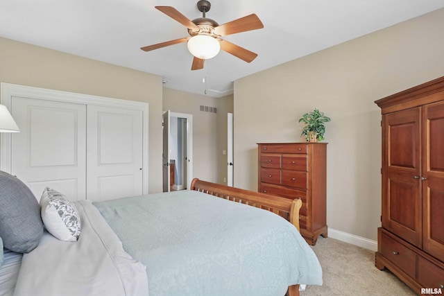11 Sandstone Ct, Le Claire, IA 52753 - bedroom featuring light colored carpet, a closet, and a ceiling fan