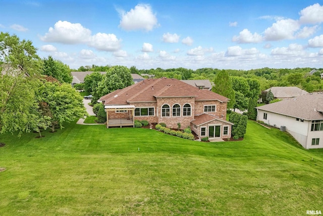 11 Sandstone Ct, Le Claire, IA 52753 - rear view of house with a yard, a deck, and brick siding