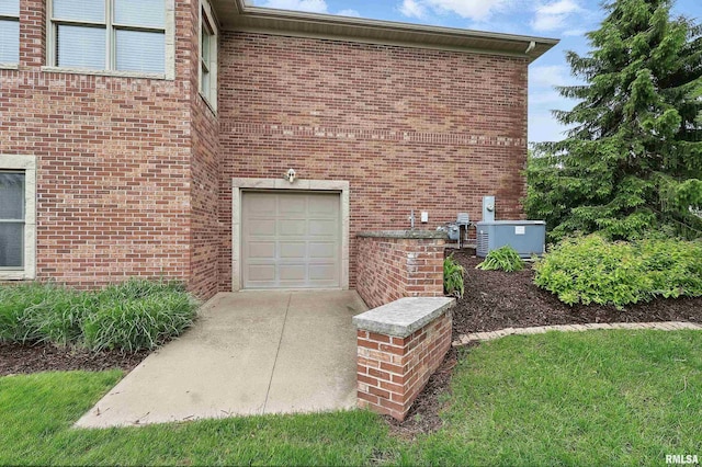 11 Sandstone Ct, Le Claire, IA 52753 - view of side of home featuring brick siding and a central AC unit