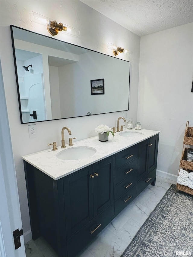 323 N Vail St, Geneseo, IL 61254 - full bathroom with double vanity, marble finish flooring, and a textured ceiling