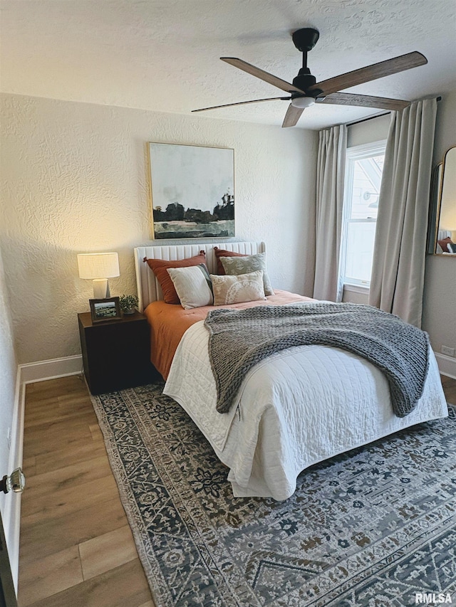 323 N Vail St, Geneseo, IL 61254 - bedroom featuring a textured wall, wood finished floors, a ceiling fan, and a textured ceiling