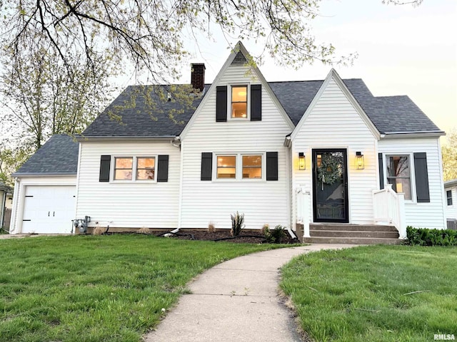 323 N Vail St, Geneseo, IL 61254 - view of front of house with a chimney, a front yard, roof with shingles, and an attached garage