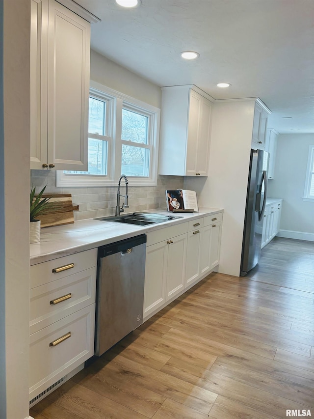 323 N Vail St, Geneseo, IL 61254 - kitchen featuring stainless steel appliances, tasteful backsplash, light wood-type flooring, light countertops, and recessed lighting