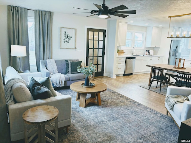 323 N Vail St, Geneseo, IL 61254 - living area featuring light wood-style floors, a ceiling fan, and a textured ceiling