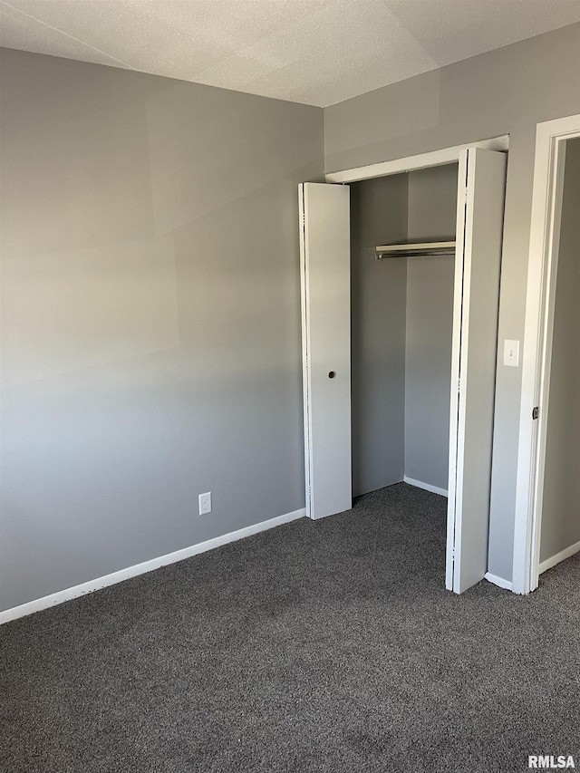 1951 Bristol Dr, Bettendorf, IA 52722 - unfurnished bedroom featuring dark colored carpet and a closet