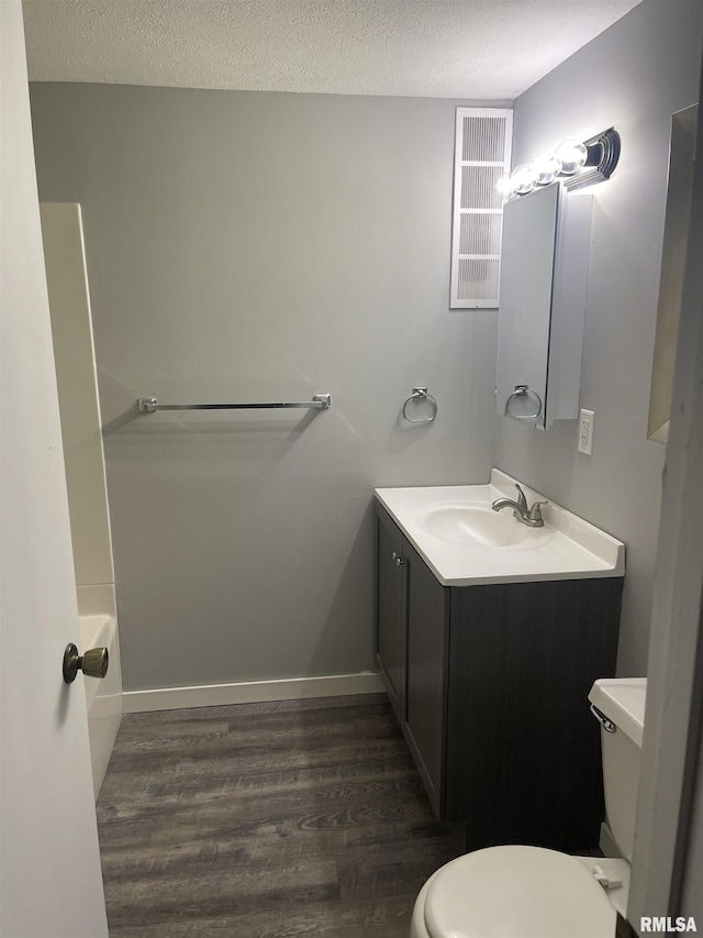 1951 Bristol Dr, Bettendorf, IA 52722 - bathroom with wood finished floors, vanity, and a textured ceiling