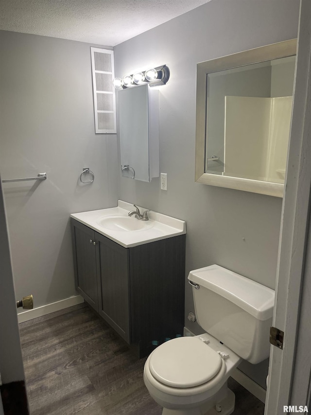 1951 Bristol Dr, Bettendorf, IA 52722 - bathroom featuring wood finished floors, a textured ceiling, and vanity