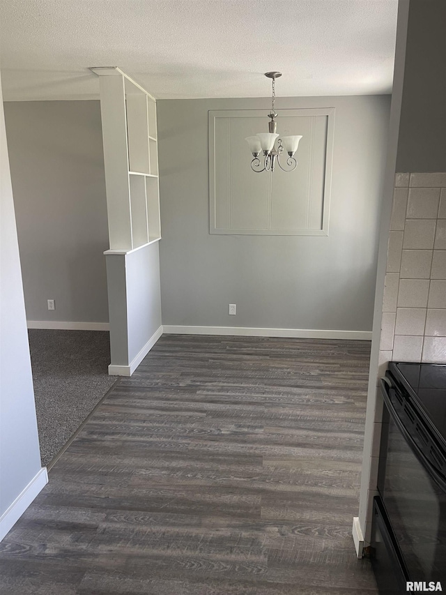 1951 Bristol Dr, Bettendorf, IA 52722 - unfurnished dining area with a chandelier, dark wood-type flooring, and a textured ceiling