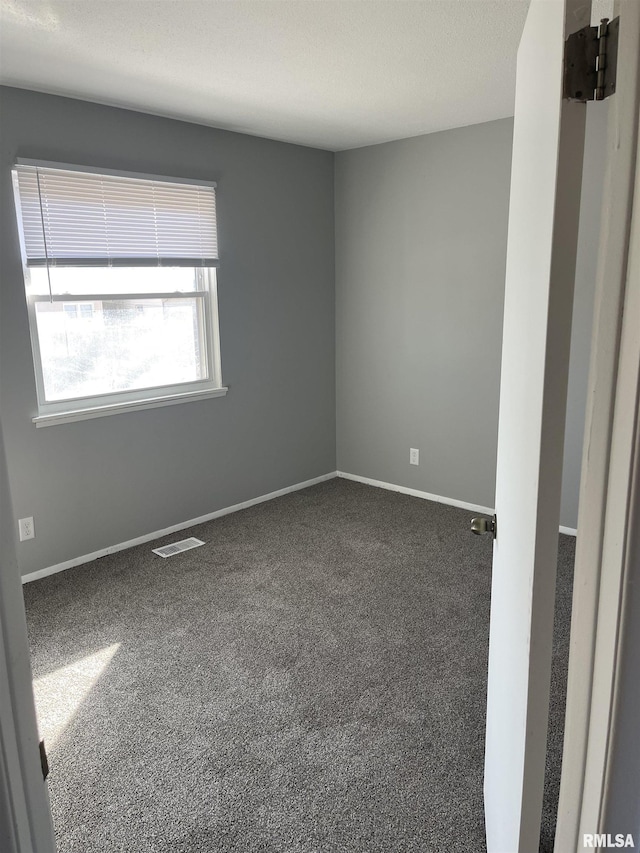 1951 Bristol Dr, Bettendorf, IA 52722 - spare room with dark colored carpet and baseboards