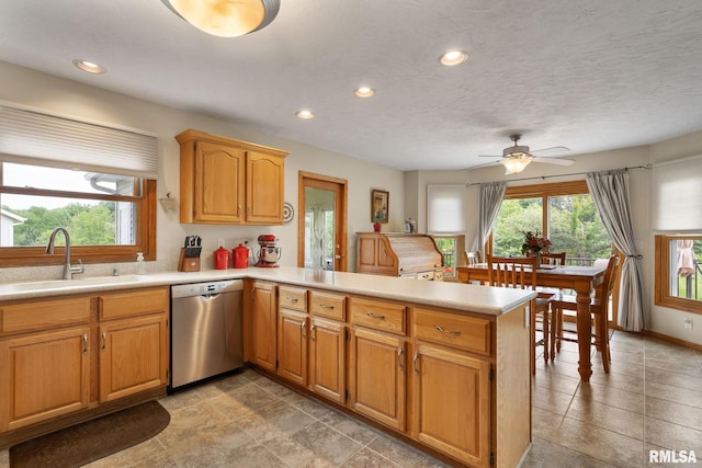 1010 Meadows Cir, Bettendorf, IA 52722 - kitchen with dishwasher, a peninsula, light countertops, recessed lighting, and a ceiling fan