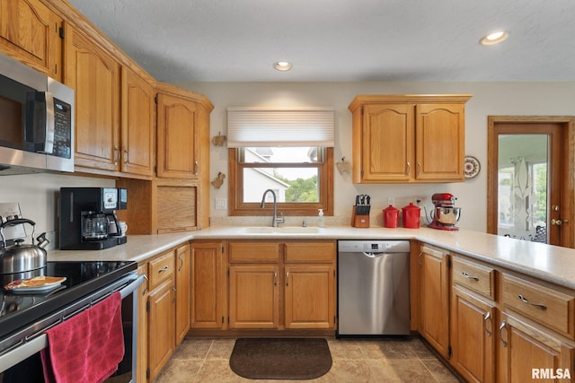 1010 Meadows Cir, Bettendorf, IA 52722 - kitchen with stainless steel appliances, healthy amount of natural light, light countertops, recessed lighting, and a peninsula
