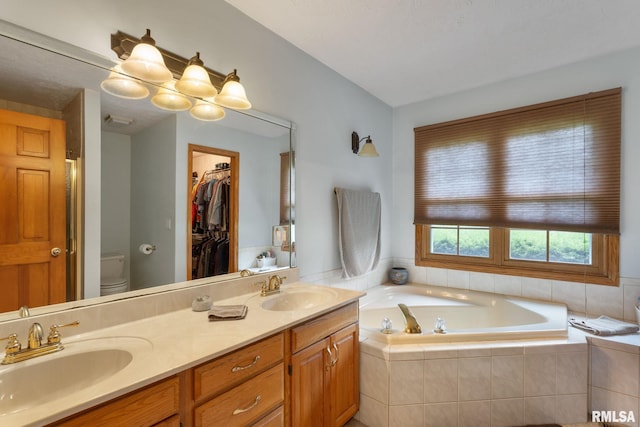 1010 Meadows Cir, Bettendorf, IA 52722 - bathroom with a bath, double vanity, and a spacious closet