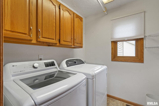 1010 Meadows Cir, Bettendorf, IA 52722 - laundry room featuring separate washer and dryer and cabinet space