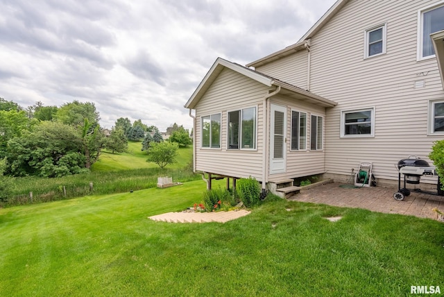 1010 Meadows Cir, Bettendorf, IA 52722 - back of property with a patio area, a lawn, and entry steps
