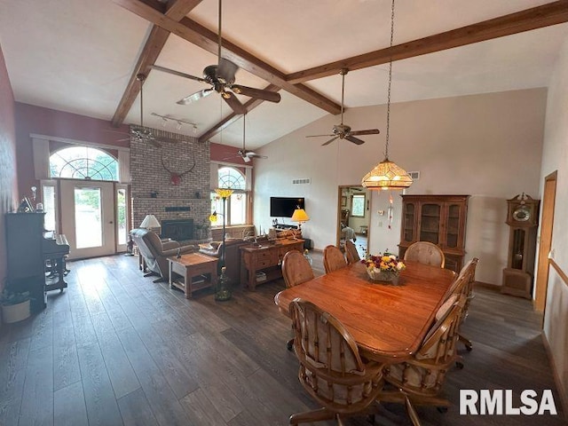 2347 230th Ave, Grand Mound, IA 52751 - dining area with beam ceiling, high vaulted ceiling, healthy amount of natural light, dark wood-style floors, and a brick fireplace