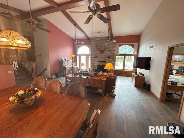 2347 230th Ave, Grand Mound, IA 52751 - dining room featuring a ceiling fan, hardwood / wood-style flooring, stairs, beamed ceiling, and a fireplace