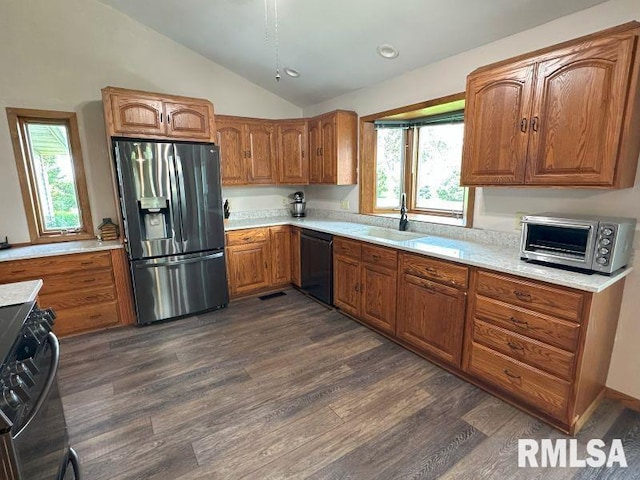 2347 230th Ave, Grand Mound, IA 52751 - kitchen with stainless steel refrigerator with ice dispenser, dishwasher, range, vaulted ceiling, and brown cabinetry