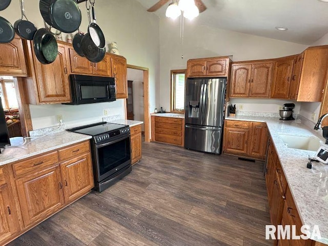2347 230th Ave, Grand Mound, IA 52751 - kitchen with stainless steel appliances, brown cabinets, dark wood-style floors, high vaulted ceiling, and ceiling fan