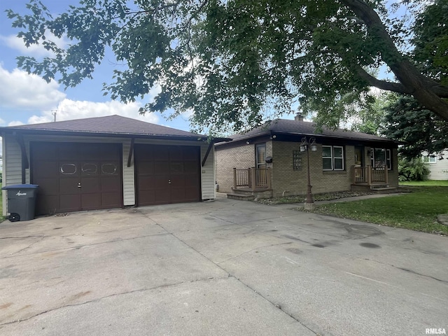 448 E 4th St, Milan, IL 61264 - view of front of home featuring brick siding, concrete driveway, and an attached garage