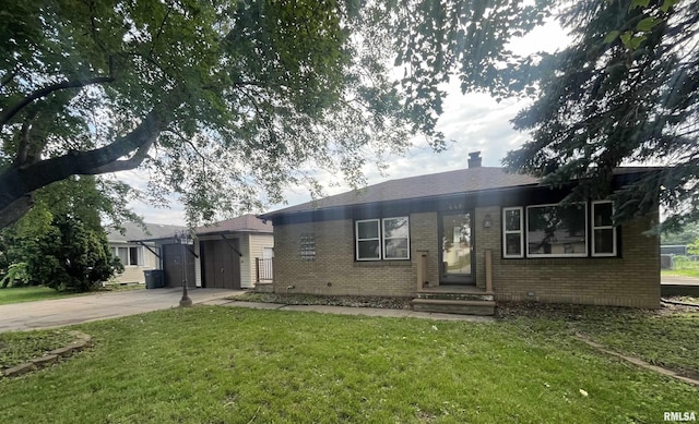 448 E 4th St, Milan, IL 61264 - view of front of house with brick siding, concrete driveway, a front yard, and crawl space