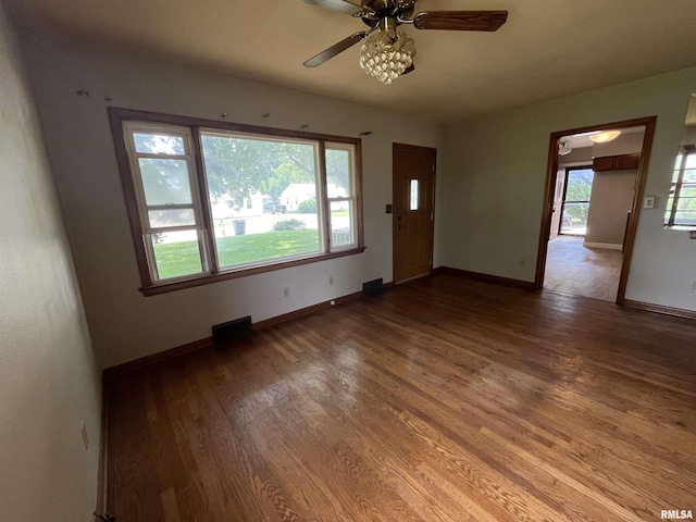 448 E 4th St, Milan, IL 61264 - unfurnished living room featuring ceiling fan and wood finished floors