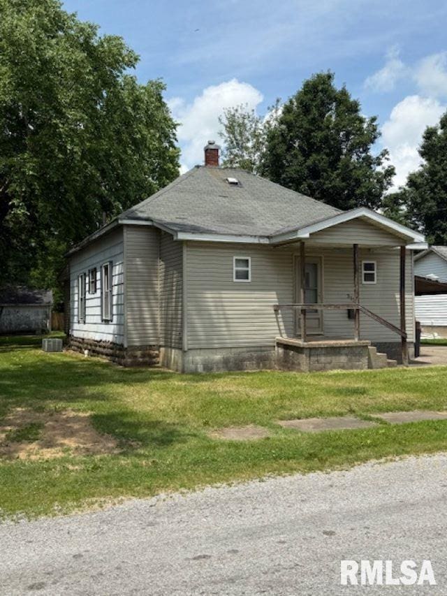 313 E 4th St, West Frankfort, IL 62896 - bungalow with a chimney, a front lawn, and a porch
