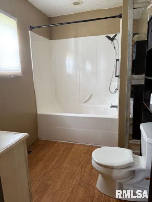 313 E 4th St, West Frankfort, IL 62896 - full bathroom featuring bathtub / shower combination, vanity, and wood finished floors