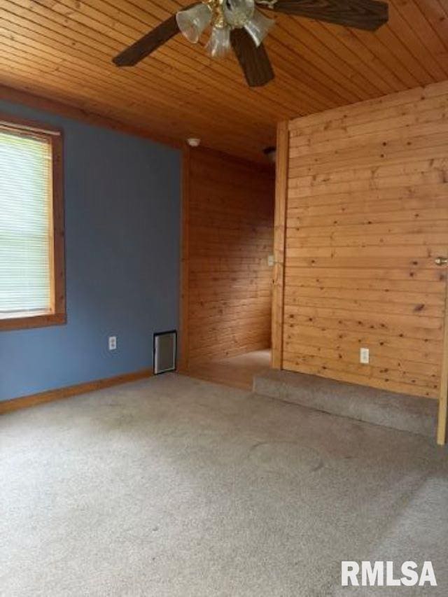 313 E 4th St, West Frankfort, IL 62896 - unfurnished room with ceiling fan, wood walls, carpet floors, and wood ceiling