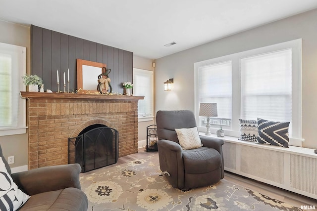 850 27th St, Rock Island, IL 61201 - living room with radiator heating unit, plenty of natural light, and wood finished floors