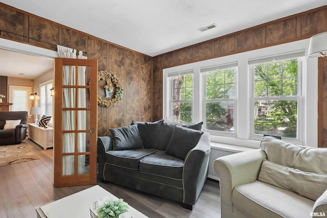 850 27th St, Rock Island, IL 61201 - living area featuring wooden walls, plenty of natural light, and wood finished floors
