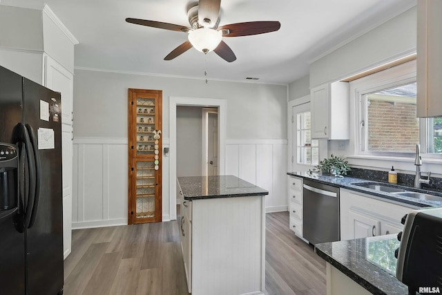 850 27th St, Rock Island, IL 61201 - kitchen with black fridge with ice dispenser, stainless steel dishwasher, a kitchen island, a ceiling fan, and healthy amount of natural light